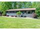 Charming one-story home with lush front lawn and mature landscaping at 119 Meadowbrook Ln, Davidson, NC 28036