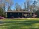 Inviting single-story home featuring a beautifully landscaped front yard and a freshly painted exterior at 119 Meadowbrook Ln, Davidson, NC 28036