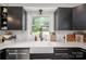 Close-up of the kitchen sink area with a window view and updated appliances at 119 Meadowbrook Ln, Davidson, NC 28036