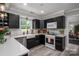 Modern kitchen with dark cabinetry, white countertops, and stainless steel appliances at 119 Meadowbrook Ln, Davidson, NC 28036
