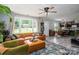 Inviting living room with large windows, modern furnishings, and a stylish area rug at 119 Meadowbrook Ln, Davidson, NC 28036