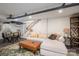 Finished basement featuring a comfortable sofa, dining table, and easy access to the stairs at 119 Meadowbrook Ln, Davidson, NC 28036
