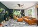 Bright living room featuring large windows, modern decor, and hardwood floors at 119 Meadowbrook Ln, Davidson, NC 28036