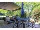 Charming outdoor seating area with a round table, chairs, and umbrella for al fresco dining and relaxation at 119 Meadowbrook Ln, Davidson, NC 28036