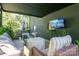 Inviting covered patio with comfortable seating area, ideal for relaxing and enjoying the outdoors at 119 Meadowbrook Ln, Davidson, NC 28036
