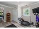 Well-lit workout room showcasing a wall mirror, wood floors, and exercise equipment near a bright window at 119 Meadowbrook Ln, Davidson, NC 28036