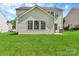 Backyard with lush grass and an exterior view of the home at 1216 Stourbridge Lion Dr, Charlotte, NC 28213