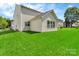 Home exterior with lush backyard lawn on a sunny day at 1216 Stourbridge Lion Dr, Charlotte, NC 28213