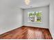 Bright bedroom features hardwood floors, a window with natural light, and neutral paint at 1216 Stourbridge Lion Dr, Charlotte, NC 28213