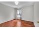 Bedroom with hardwood floors, large window, and light gray walls at 1216 Stourbridge Lion Dr, Charlotte, NC 28213