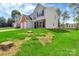 Two-story home with brick and vinyl siding, offering a spacious two-car garage and a well-maintained lawn at 1216 Stourbridge Lion Dr, Charlotte, NC 28213