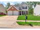 Charming two-story home with a brick and vinyl exterior, two-car garage, and well-manicured lawn at 1216 Stourbridge Lion Dr, Charlotte, NC 28213