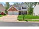 Charming two-story home features a brick facade, two-car garage, and manicured front lawn at 1216 Stourbridge Lion Dr, Charlotte, NC 28213