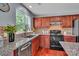 This updated kitchen features stainless steel appliances, a black range, and stunning granite countertops at 1216 Stourbridge Lion Dr, Charlotte, NC 28213