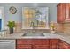 The kitchen window provides light over granite countertops with a modern faucet and view to the backyard at 1216 Stourbridge Lion Dr, Charlotte, NC 28213