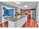 Open kitchen with a large center island, stainless steel appliances, and warm wood cabinetry at 1216 Stourbridge Lion Dr, Charlotte, NC 28213