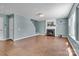 Living room with fireplace and mantel, tile flooring, and bright, sunlit windows at 1216 Stourbridge Lion Dr, Charlotte, NC 28213