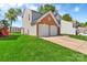 Side view of the home with a two-car garage and lush green lawn, perfect for outdoor activities at 1216 Stourbridge Lion Dr, Charlotte, NC 28213