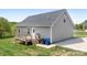 Wooden deck and concrete pad provide spaces for relaxation and recreation in the backyard at 123 Pumice Dr, Statesville, NC 28625