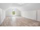 Bright upper bedroom featuring neutral walls and a large window for natural light at 123 Pumice Dr, Statesville, NC 28625
