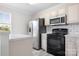 Bright kitchen with stainless steel refrigerator and black oven at 123 Pumice Dr, Statesville, NC 28625