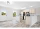 Open-concept kitchen featuring white cabinets and stainless steel appliances at 123 Pumice Dr, Statesville, NC 28625