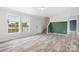 Bright and airy living room with wood-look floors, large windows, and staircase at 123 Pumice Dr, Statesville, NC 28625