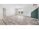 Bright living room with wood-look floors, large windows and a white front door at 123 Pumice Dr, Statesville, NC 28625