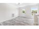 View of the bright living room with wood-look floors and a back door at 123 Pumice Dr, Statesville, NC 28625