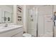 Well-lit bathroom features a sleek, modern shower with glass enclosure, bright white cabinets, and contemporary fixtures at 14018 Wilson Mac Ln, Charlotte, NC 28278
