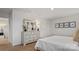 Spacious bedroom featuring a cozy queen bed, and a well appointed dresser with a large mirror above at 14018 Wilson Mac Ln, Charlotte, NC 28278