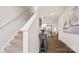Inviting foyer with hardwood floors, staircase, and decorative console table at 14018 Wilson Mac Ln, Charlotte, NC 28278