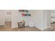 Inviting hallway with neutral carpeting, leading to bedrooms and accented with decorative shelves and a cozy beanbag chair at 14018 Wilson Mac Ln, Charlotte, NC 28278