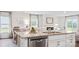 Bright kitchen with white cabinets, granite countertops, stainless steel appliances, and a view of the living area at 14018 Wilson Mac Ln, Charlotte, NC 28278