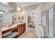 Main bath features a vanity area with a stool, cabinets, and a shower with a glass door at 141 Ivy Creek Ln, Mooresville, NC 28115