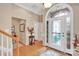 Bright foyer showcasing a beautiful front door, hardwood floors, and staircase at 141 Ivy Creek Ln, Mooresville, NC 28115
