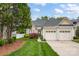 Charming home featuring a two-car garage, well-maintained lawn, and mature landscaping at 141 Ivy Creek Ln, Mooresville, NC 28115
