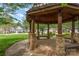 Interior view of a gazebo featuring stone supports, wooden beams, and benches at 141 Ivy Creek Ln, Mooresville, NC 28115