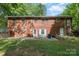 Brick home featuring a spacious backyard with a patio, ideal for outdoor activities and relaxation at 1444 Harris St, Statesville, NC 28677