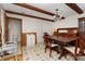 Dining area with a large wooden table, patterned tile flooring, and exposed beams at 1444 Harris St, Statesville, NC 28677