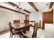 Dining room with wood table, chairs, ceiling beams and tiled floor at 1444 Harris St, Statesville, NC 28677