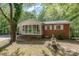 Charming brick home featuring a screened-in porch and well-maintained landscaping at 1444 Harris St, Statesville, NC 28677
