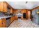 Kitchen featuring stainless steel appliances, oak cabinets, and tiled backsplash at 1444 Harris St, Statesville, NC 28677
