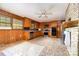 Kitchen features appliances, wood cabinets, and tile backsplash and flooring at 1444 Harris St, Statesville, NC 28677