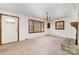Living room with neutral carpet, brick fireplace, chandelier, and wood-framed windows at 1444 Harris St, Statesville, NC 28677