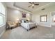 Spacious bedroom featuring a tray ceiling, neutral tones, and large windows for natural light at 15133 Rocky Bluff Loop, Davidson, NC 28036