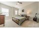 Bright bedroom featuring a ceiling fan, windows, and decorative accents at 15133 Rocky Bluff Loop, Davidson, NC 28036