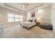 Spacious bedroom with tray ceiling, neutral tones, and a large window offering ample natural light at 15133 Rocky Bluff Loop, Davidson, NC 28036