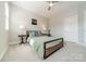 Well-lit bedroom with neutral colors, a bed, and decorative lamps at 15133 Rocky Bluff Loop, Davidson, NC 28036