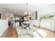 Open dining area flows into kitchen and living space with a modern chandelier and hardwood floors at 15133 Rocky Bluff Loop, Davidson, NC 28036